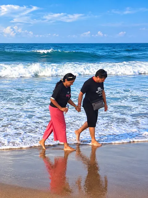Couple walking on Poovar golden sand beach – Poovar Boating